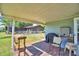 Charming covered back porch with brick flooring, offering an outdoor dining and relaxation area at 2836 Magnolia Ave, Lakeland, FL 33812