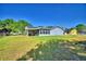 Spacious backyard featuring a covered patio and solar panels, perfect for outdoor entertaining and energy efficiency at 2836 Magnolia Ave, Lakeland, FL 33812