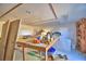Unfinished basement with wooden work tables and shelving at 2836 Magnolia Ave, Lakeland, FL 33812