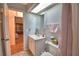 Bright bathroom featuring a single sink vanity, medicine cabinet, and shower with a floral curtain at 2836 Magnolia Ave, Lakeland, FL 33812