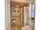 Bathroom features an updated step-in shower with hand rails and neutral walls at 2836 Magnolia Ave, Lakeland, FL 33812