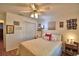 Charming bedroom featuring light walls, a ceiling fan, and laminate flooring with a view into the hallway at 2836 Magnolia Ave, Lakeland, FL 33812