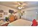 Bright bedroom featuring a ceiling fan, closet and dresser space, and a comfortable bed at 2836 Magnolia Ave, Lakeland, FL 33812