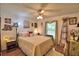 Cozy bedroom with ceiling fan, laminate flooring, and a window providing natural light at 2836 Magnolia Ave, Lakeland, FL 33812