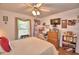 Comfortable bedroom with a ceiling fan, laminate floors, and a window for natural light at 2836 Magnolia Ave, Lakeland, FL 33812