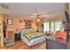 A spacious bedroom featuring wood floors, a ceiling fan, and access to the outdoors at 2836 Magnolia Ave, Lakeland, FL 33812