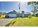 Beautiful single-Gathering home with lush green lawn, solar panels, and an American flag waving high at 2836 Magnolia Ave, Lakeland, FL 33812
