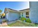 Charming single-story home with blue siding, a well-manicured lawn, and solar panels on the roof at 2836 Magnolia Ave, Lakeland, FL 33812