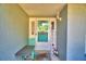 Inviting front entrance features a charming aqua door and welcome sign for a warm and cheerful appeal at 2836 Magnolia Ave, Lakeland, FL 33812