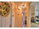 Hallway featuring warm colors, decorative lighting and view to kitchen at 2836 Magnolia Ave, Lakeland, FL 33812