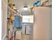 Bright laundry room featuring modern washer and dryer, storage shelving, and tile flooring at 2836 Magnolia Ave, Lakeland, FL 33812