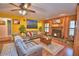 Cozy living room features a fireplace, wood paneling, and built-in shelving for a warm feel at 2836 Magnolia Ave, Lakeland, FL 33812