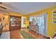 Bright living room featuring wood floors, a cabinet and large windows at 2836 Magnolia Ave, Lakeland, FL 33812