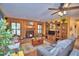 Comfortable living room features a stone fireplace, wood paneled walls, and built-in shelving at 2836 Magnolia Ave, Lakeland, FL 33812