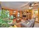 Comfortable living room features a stone fireplace, wood paneled walls, and built-in shelving at 2836 Magnolia Ave, Lakeland, FL 33812
