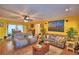 Inviting living room with neutral toned furniture, ceiling fan, and large art piece at 2836 Magnolia Ave, Lakeland, FL 33812