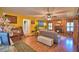 Spacious living room with hardwood floors, fireplace, and wood paneling at 2836 Magnolia Ave, Lakeland, FL 33812