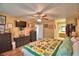 A vibrant main bedroom showcasing wood floors, ceiling fan, and plenty of storage at 2836 Magnolia Ave, Lakeland, FL 33812