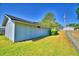 Outdoor shed with ample storage space, set against a backdrop of green grass and blue skies at 2836 Magnolia Ave, Lakeland, FL 33812