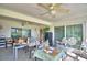 Bright sunroom with ceiling fans, large windows, and tile flooring, providing a versatile and comfortable space at 2836 Magnolia Ave, Lakeland, FL 33812