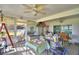 Cozy sunroom with tiled floor, many windows, a fan, and casual decor for relaxation and enjoyment at 2836 Magnolia Ave, Lakeland, FL 33812