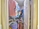 Organized walk-in closet with clothing racks, shoe shelves, and suitcases for ample storage space at 2836 Magnolia Ave, Lakeland, FL 33812