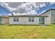 A view of the green backyard that offers ample space for outdoor activities and entertainment at 3208 Weitzel Dr, Haines City, FL 33844