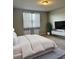 Bedroom featuring plush carpet, neutral walls, and modern window coverings for a cozy retreat at 3208 Weitzel Dr, Haines City, FL 33844