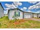 Charming single-story home featuring a one-car garage, well-maintained lawn, and beautiful landscaping at 3208 Weitzel Dr, Haines City, FL 33844