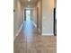 Inviting hallway with tile flooring, neutral walls, and plenty of natural light flowing throughout at 3208 Weitzel Dr, Haines City, FL 33844