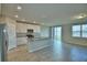 Kitchen and living area featuring stainless steel appliances, granite counters, and an island for meal preparation at 3208 Weitzel Dr, Haines City, FL 33844