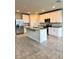 Bright kitchen with stainless steel appliances, granite countertops, kitchen island, and open layout to the dining area at 3208 Weitzel Dr, Haines City, FL 33844