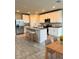 Bright kitchen with stainless steel appliances, granite countertops, kitchen island, and open layout to the dining area at 3208 Weitzel Dr, Haines City, FL 33844