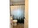 Updated bathroom features a shower with decorative curtain, new vanity and flooring at 3227 Decatur Ave, Lakeland, FL 33805
