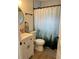 Updated bathroom features a shower with curtain, new vanity and modern fixtures at 3227 Decatur Ave, Lakeland, FL 33805
