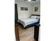 Cozy bedroom with a comfortable bed, wood-look flooring, and stylish decor at 3227 Decatur Ave, Lakeland, FL 33805