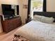 Comfortable bedroom with wooden dresser and natural light at 3227 Decatur Ave, Lakeland, FL 33805