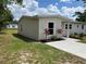 Side view of a newly painted home with green lawn, landscaping, new driveway and walkways at 3227 Decatur Ave, Lakeland, FL 33805