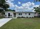 Inviting single-story home with a lush lawn, refreshed exterior paint, and modern landscaping at 3227 Decatur Ave, Lakeland, FL 33805