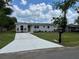 Attractive one-story home with a new driveway, grassy lawn and manicured landscaping around the house at 3227 Decatur Ave, Lakeland, FL 33805