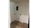 Hallway with wood flooring and white paneled doors showcasing modern hardware at 3227 Decatur Ave, Lakeland, FL 33805