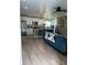 Spacious open kitchen featuring an island with pendant lighting, stainless appliances and hardwood floors at 3227 Decatur Ave, Lakeland, FL 33805