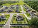 Aerial view of a neighborhood with homes, well-kept lawns, and fenced yards, located in a residential community at 3425 Sutton Ridge St, Lakeland, FL 33810