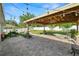 Paved backyard patio with an outdoor seating area, barbeque grill, and landscaped yard at 3425 Sutton Ridge St, Lakeland, FL 33810