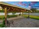 Relaxing backyard patio with a covered pergola, stone pavers, and decorative string lights for outdoor enjoyment at 3425 Sutton Ridge St, Lakeland, FL 33810