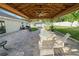 Backyard patio area with dining table, barbecue grill, and outdoor lighting at 3425 Sutton Ridge St, Lakeland, FL 33810