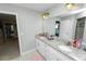 Bright bathroom featuring double sinks, granite counters, and a separate shower with a tiled surround at 3425 Sutton Ridge St, Lakeland, FL 33810