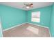 Bedroom featuring teal walls, carpet flooring, a ceiling fan, and a window for natural light at 3425 Sutton Ridge St, Lakeland, FL 33810
