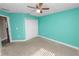 Bedroom showing a carpet floor, teal walls, and a closet at 3425 Sutton Ridge St, Lakeland, FL 33810