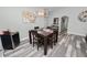 Dining room with wood table, chandelier, and wood-look tile flooring at 3425 Sutton Ridge St, Lakeland, FL 33810